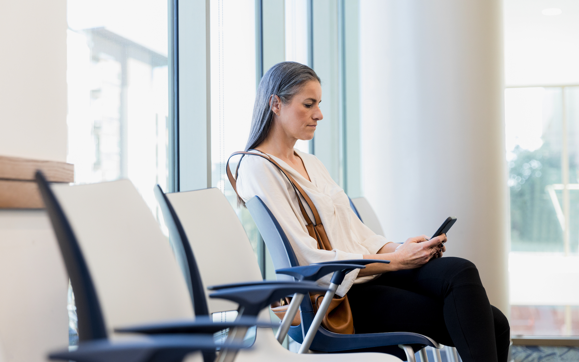 Woman sits in waiting room for news about family member Woman in waiting room at doctor's office